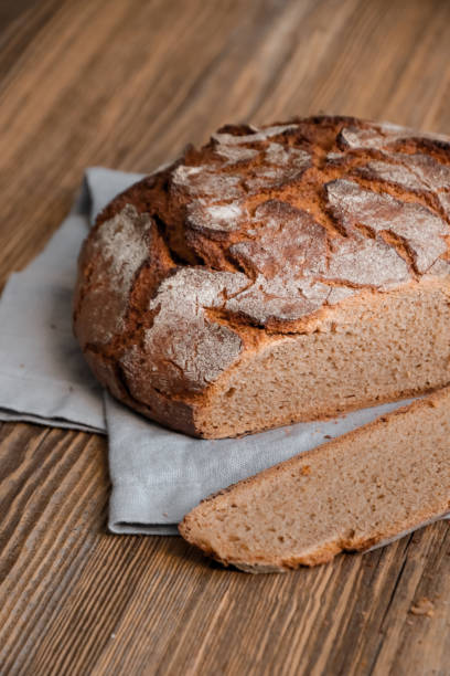 istock Homemade Bread in rustic wood kitchen cut open 1250599437