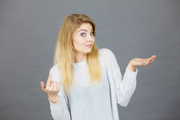 istock Young woman seek a solution, making undecided gesture 1250600802