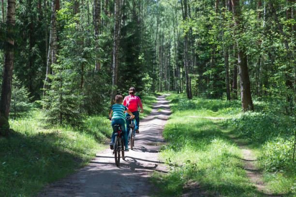 istock mother and son riding bikes in nature 1250600973