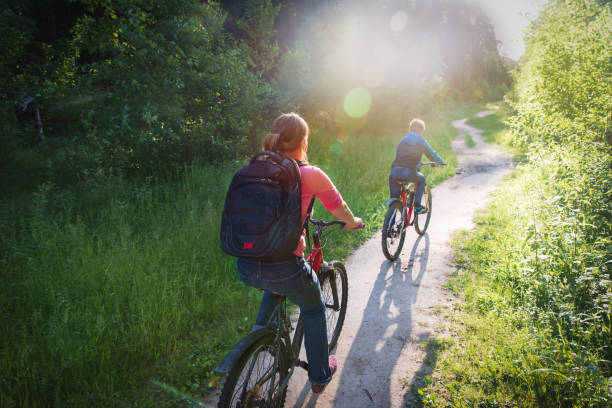 istock mother and son riding bikes in sunset nature 1250601012