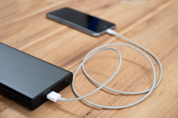 istock A mobile phone placed on a wooden table charging the battery 1250603309