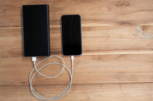 istock A mobile phone placed on a wooden table charging the battery 1250603317