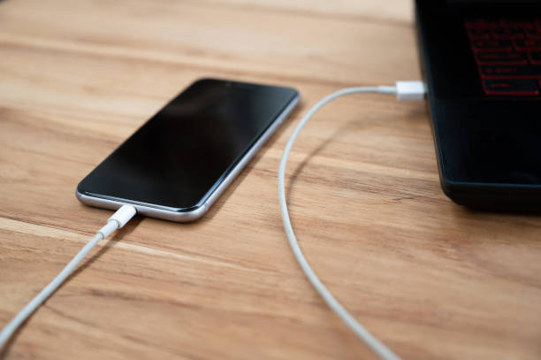 istock A mobile phone placed on a wooden table charging the battery 1250603321