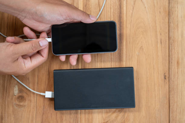 istock A mobile phone placed on a wooden table charging the battery 1250603325