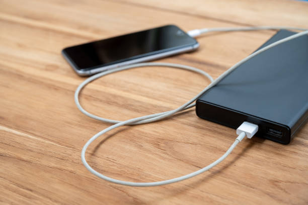 istock A mobile phone placed on a wooden table charging the battery 1250603343