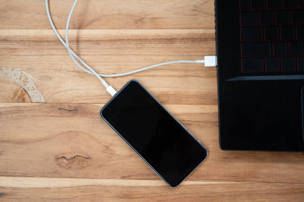 istock A mobile phone placed on a wooden table charging the battery 1250603345