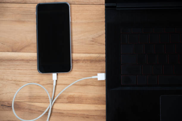 istock A mobile phone placed on a wooden table charging the battery 1250603350