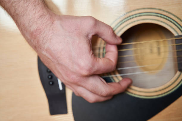 istock Musician Hand on Acoustic Guitar. Close up 1250604716