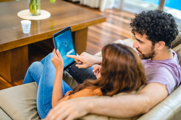 istock Couple Using Digital Tablet to Manage Home Automation System 1250610560