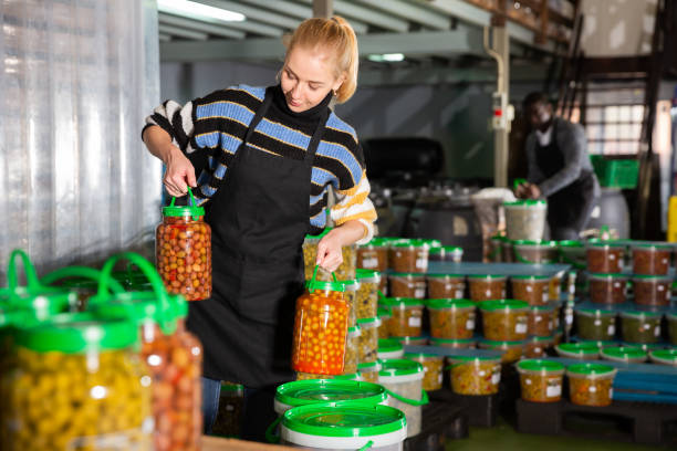 istock Workwoman carrying plastic containers with ripe olives 1250613259