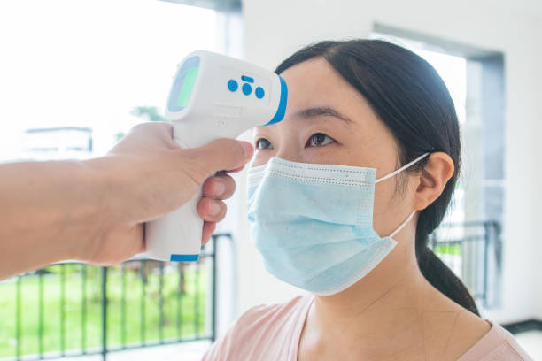 istock Young woman getting her temperature test 1250616709