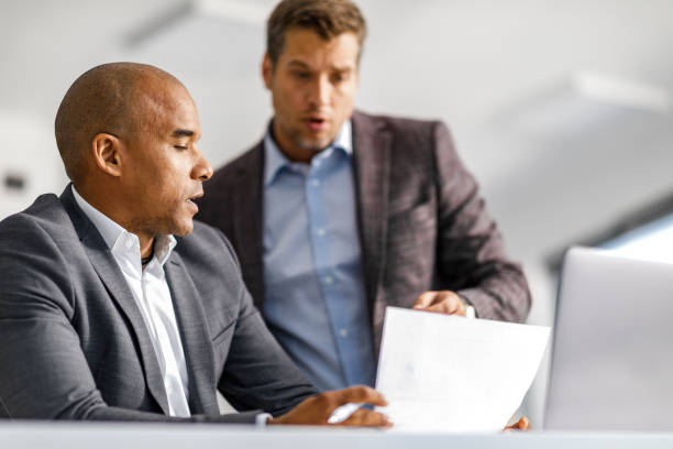 istock Male entrepreneurs analyzing business reports in the office. 1250619870