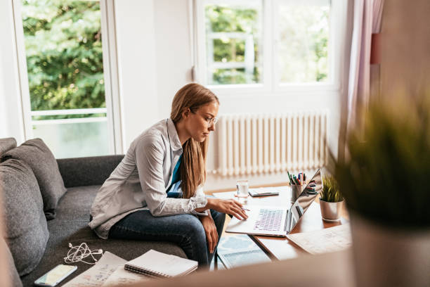 istock Serious woman working on laptop at home during covid-19 quarantine 1250620625