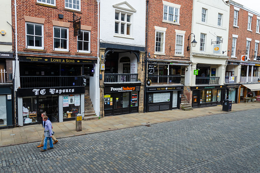 Chester, UK: Jun 14, 2020: A general street scene of Chester City centre on a Sunday afternoon. Many shops and restaurants are closed and few people due to the Covid-19 restrictions.