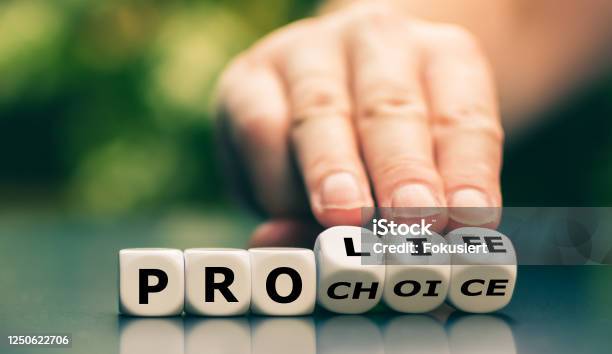 Hand Turns Dice And Changes The Expression Pro Choice To Pro Life Stock Photo - Download Image Now