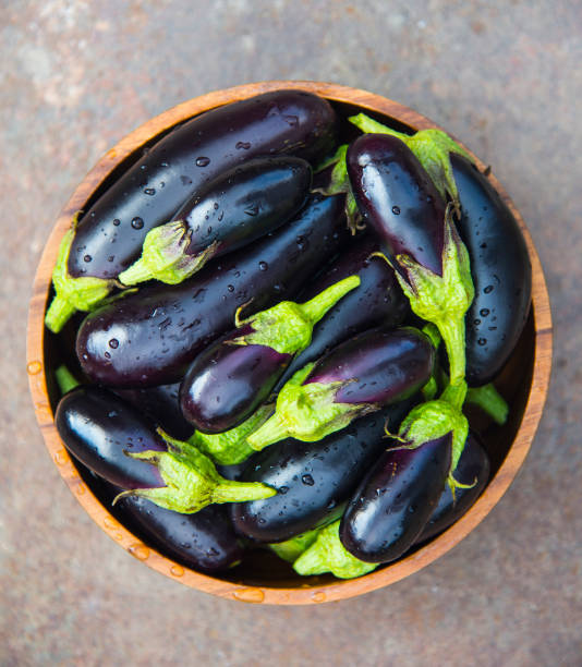 istock Ripe eggplant in a wooden bowl 1250622864