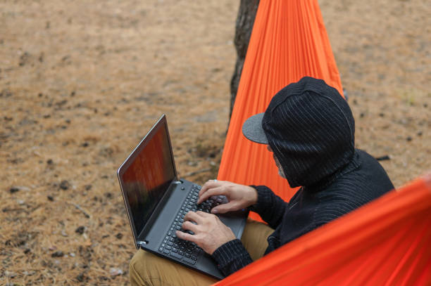 istock Portrait of a cheerful man working on computor from a remote place 1250623157