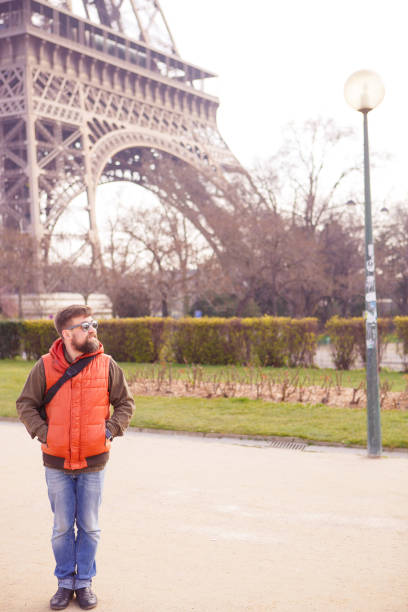 istock man in sunglasses, tourist with video camera walks in spring Paris. 1250624689