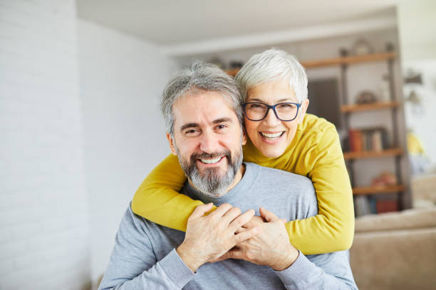 senior couple happy elderly love together man woman portrait gray hair portrait of happy smiling senior couple at home mature men photos stock pictures, royalty-free photos & images