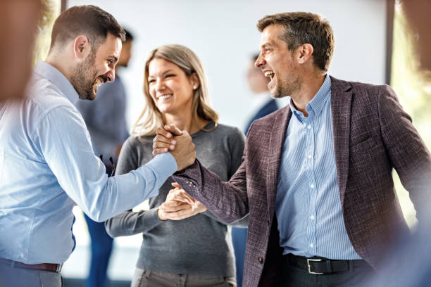 istock Cheerful businessmen greeting each other at corporate office. 1250626026
