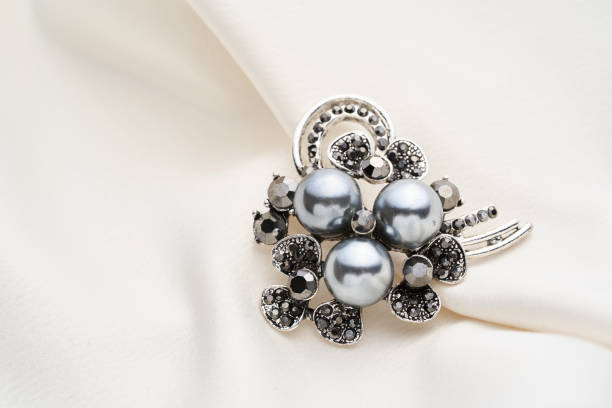 istock Silver brooch with small diamonds and black pearls,  isolated on white background. 1250626304