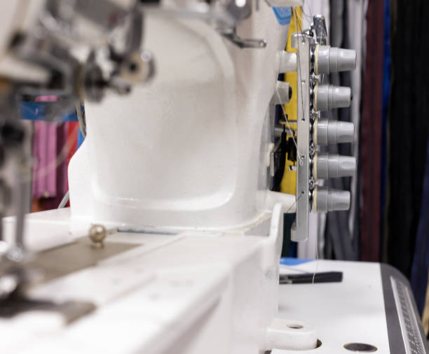 istock A professional sewing machine is in the workshop. Against the background of various devices and what a seamstress needs for work-knickknacks and tools 1250626393