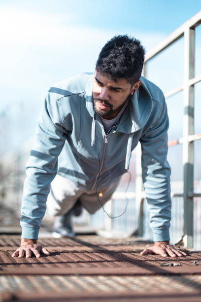 istock African American athlete making an effort while doing push-ups outside Stock photo 1250629353