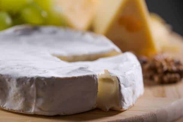 istock Different kinds of cheese on a plate with grapes and nuts 1250632905
