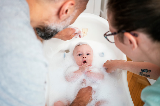 Baby bathing with his parent's