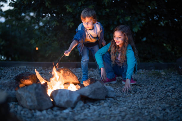 istock Small siblings enjoying by the bonfire in the evening. 1250634309