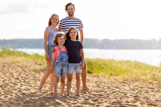 istock Young family having fun outdoors at the beach 1250634924