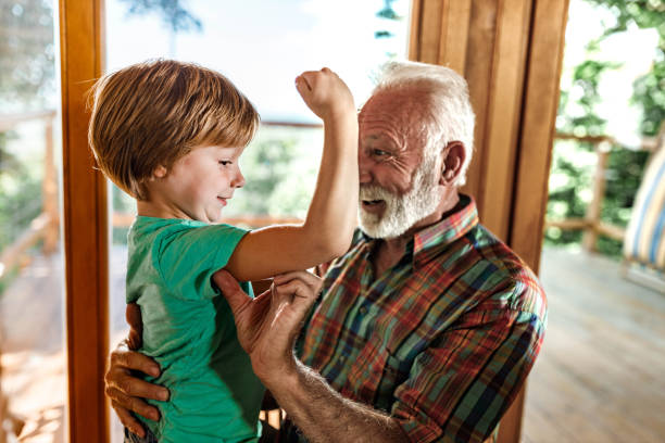 guarda i miei muscoli nonno! - flexing muscles child little boys bicep foto e immagini stock