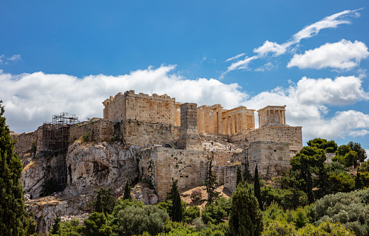 Athens, Greece. Acropolis rock and Propylaea gate, view from Areopagus hill, blue cloudy sky, spring day