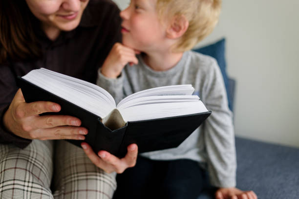 istock Mother and child reading book and smiling 1250638487