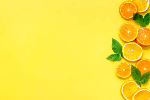 istock Sliced citrus fruits on yellow background top view 1250639958