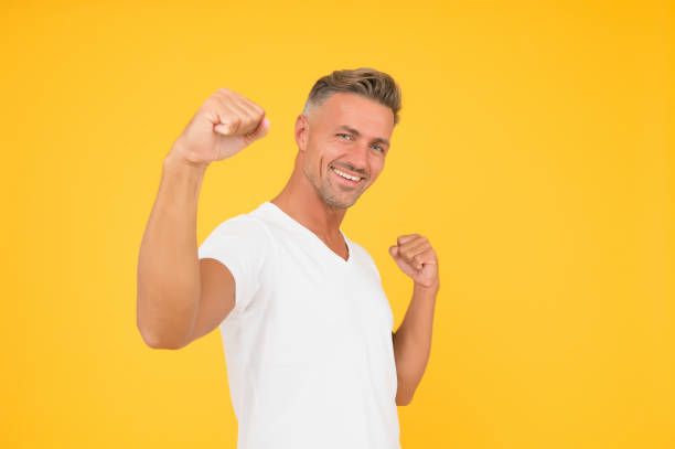 Cheerful individual enjoying a sunny day with open arms and vibrant energy. Set against an urban backdrop, the mood of the scene conveys happiness and free-spirited enthusiasm.