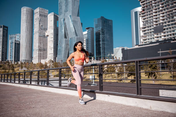 istock Female athlete running downtown 1250643552