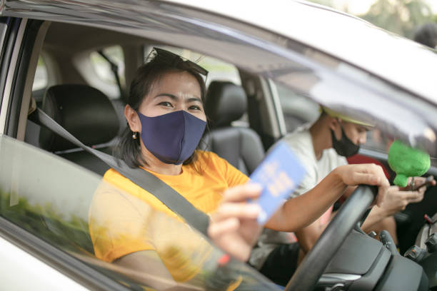 istock asian Woman with mask driving car 1250644230