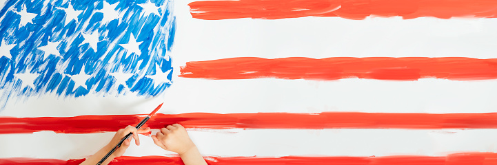 The child hands drawing the American flag. Concept of independence day, July 4. Banner.