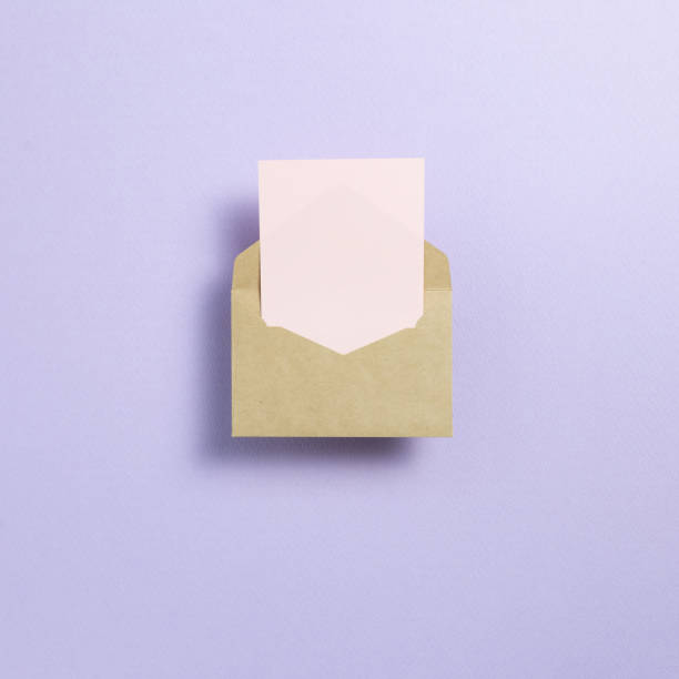 istock Kraft envelope and empty card on light purple background. top view, copy space 1250647104