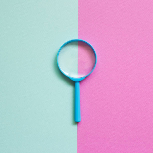 istock Blue magnifying glass on green and pink background. top view, copy space 1250647304