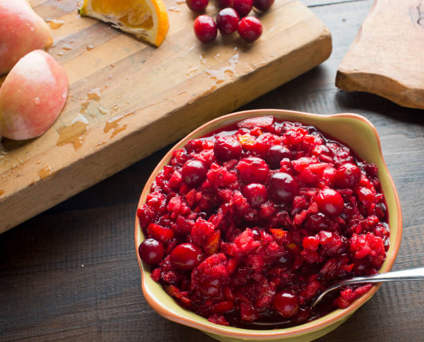 Cranberry relish made with candies mandarin oranges, toasted pecans, walnuts and topped with sugar and over roasted. Classic American thanksgiving side dish. Cranberry relish made with candies mandarin oranges, toasted pecans, walnuts and topped with sugar and over roasted. Classic American thanksgiving side dish. relish stock pictures, royalty-free photos & images