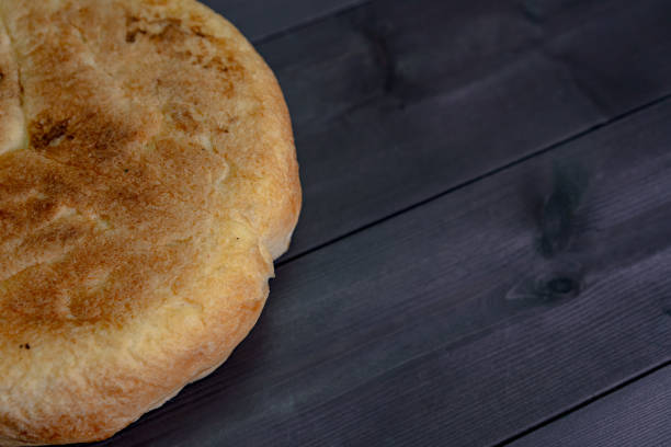 istock Fresh bread on a wooden background 1250651479