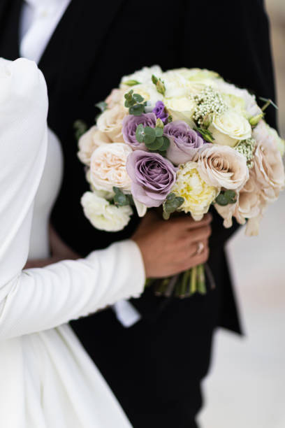 istock Couple holding a wedding bouquet. 1250651495