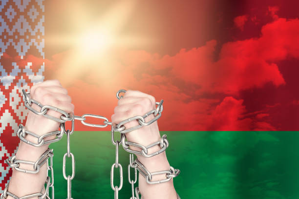 istock Two hands shackled a metal chain on Belarus flag. Freedom concept 1250652046