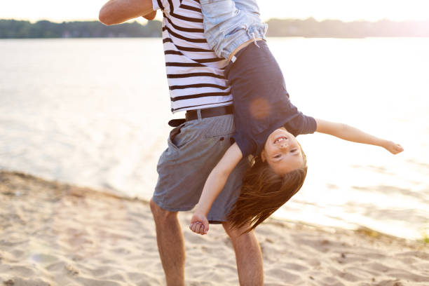 istock Father with a child spending the day at the beach 1250653554