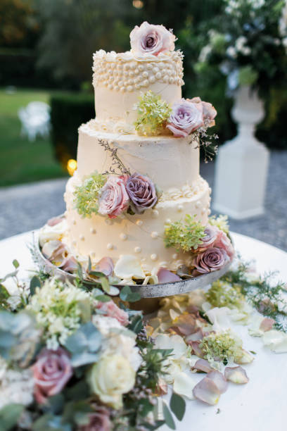 istock Wedding cake standing on the table. With the flowers. 1250653827