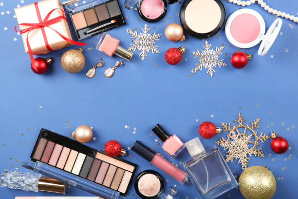 istock Beautiful composition with Christmas decor and makeup cosmetics on a colored background top view. 1250655151