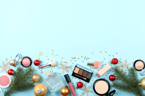 istock Beautiful composition with Christmas decor and makeup cosmetics on a colored background top view. 1250655162
