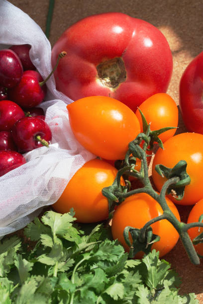 istock Juicy red berries tomatoes and cherries in sun light. 1250655192